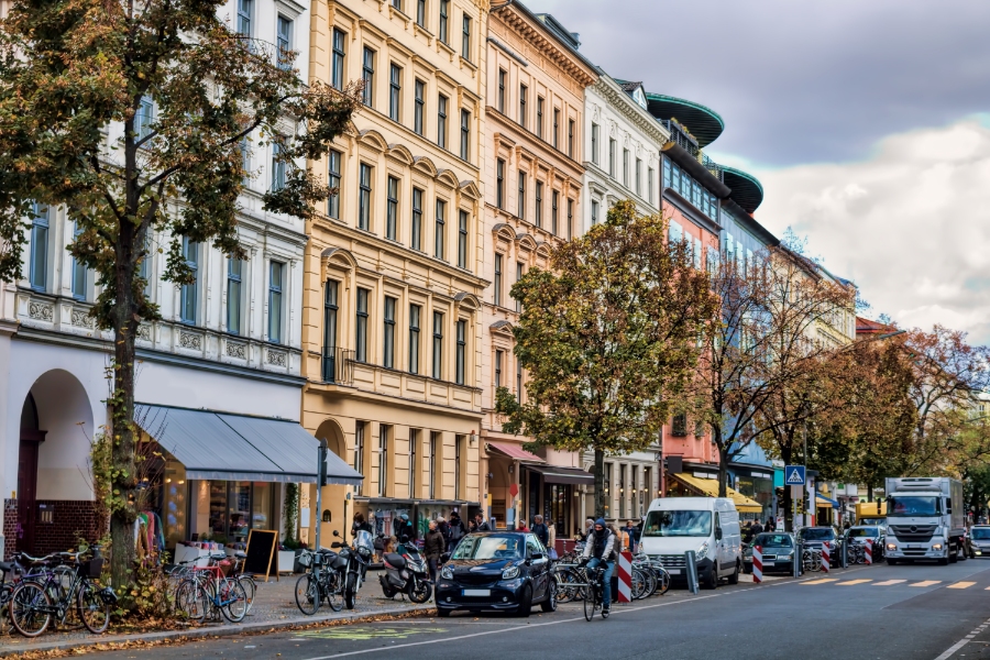 Umweltzone Guide: Germany's Low-Emission Zones Explained for Tourists 9 Urban scene in Berlin, showcasing a street lined with parked cars and diverse architectural buildings.