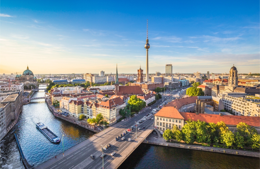 Scenic skyline of Berlin, highlighting the TV tower with a river flowing in the background.