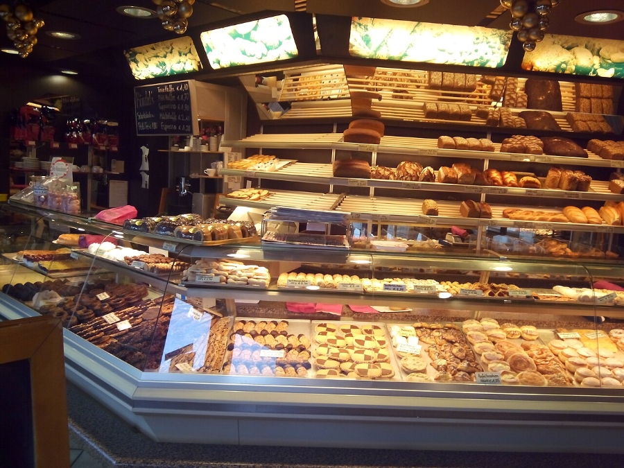 German Bread Culture: Bakeries, Loaves and Traditions 25 Interior of a Bielefeld-Jöllenbeck bakery filled with an assortment of pastries, including cakes, cookies, and bread.