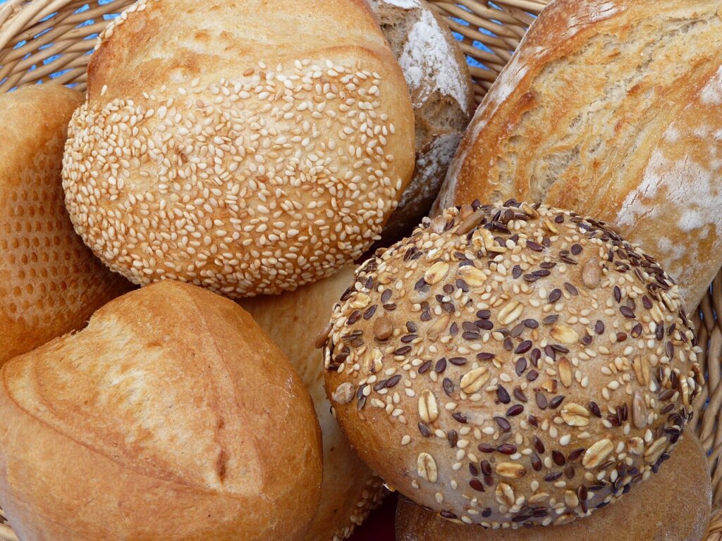 German Bread Culture: Bakeries, Loaves and Traditions 14 Rustic basket overflowing with different styles of bread rolls, showcasing their crusty textures.