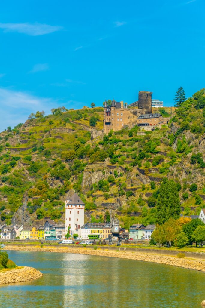 Middle Rhine Valley 26 The Rhine River flows alongside a hill topped with Burg Katz in the picturesque Rhine Valley.