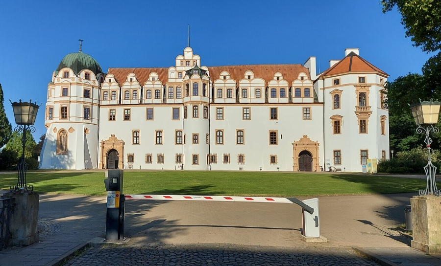 German Half-Timbered Route: Complete 7-Day Itinerary 6 Celle Castle in Germany, surrounded by lush green trees and grass, showcasing its historic architecture.