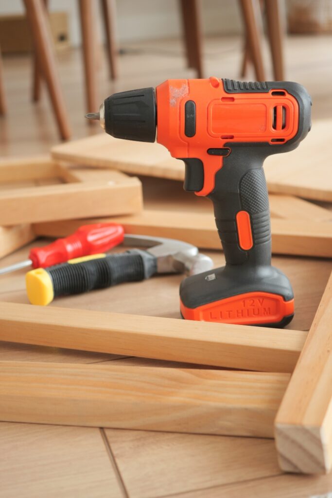 Sunday & Quiet Hours in Germany: The Complete Survival Guide 12 unny afternoon scene featuring a drill and woodworking tools placed on a wooden floor at home.