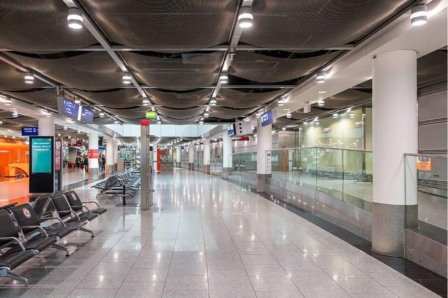 Düsseldorf Airport 9 An expansive, vacant terminal at Düsseldorf Airport, showcasing a limited number of chairs and a modern architectural design.