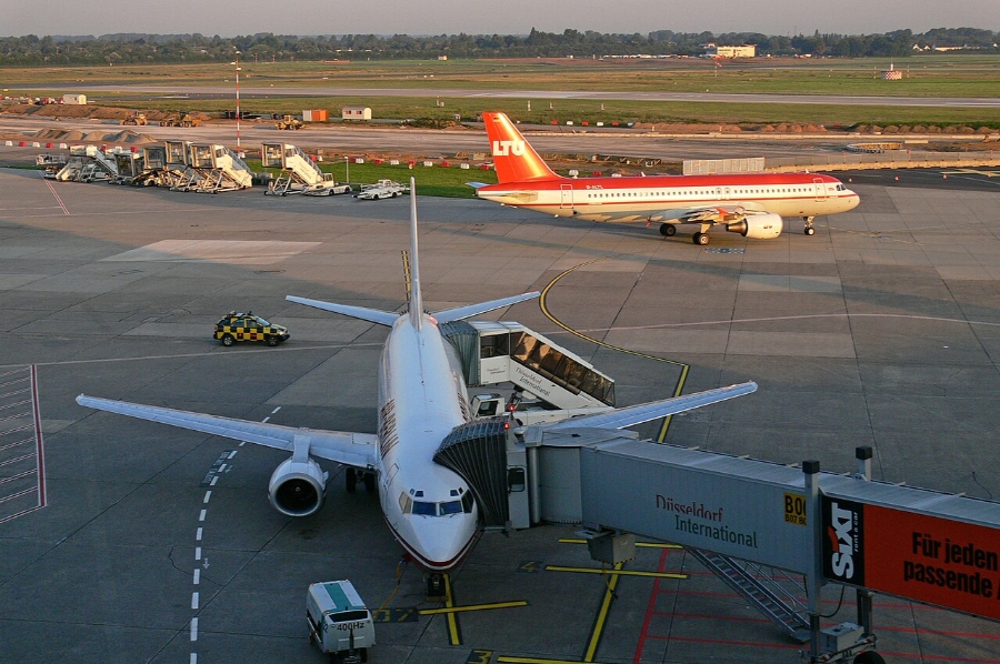 Düsseldorf Airport 6 Commercial airplane stationed on the tarmac at Düsseldorf Airport, surrounded by airport infrastructure.