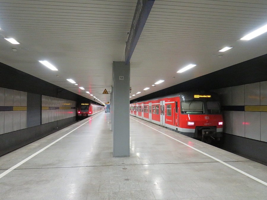 Düsseldorf Airport 15 Train enters the station at Düsseldorf Airport terminal, with people standing on the platform.