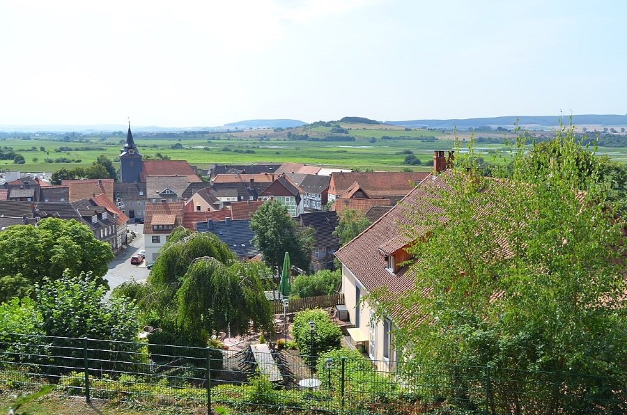 German Half-Timbered Route: Complete 7-Day Itinerary 52 Townscape of Einbeck, Germany, showcasing a prominent clock tower surrounded by charming residential buildings.