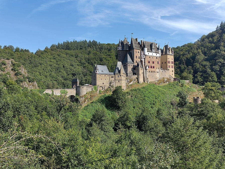 Middle Rhine Valley 19 Eltz Castle perched on a hill, surrounded by lush green trees, showcasing its medieval architecture and scenic landscape