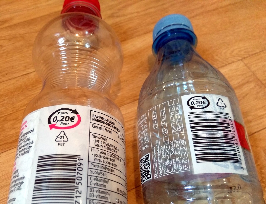 Pfand System Explained: Germany's Bottle Deposit Complete Guide 15 Two empty plastic bottles with visible barcodes on their labels, placed side by side on a neutral background.