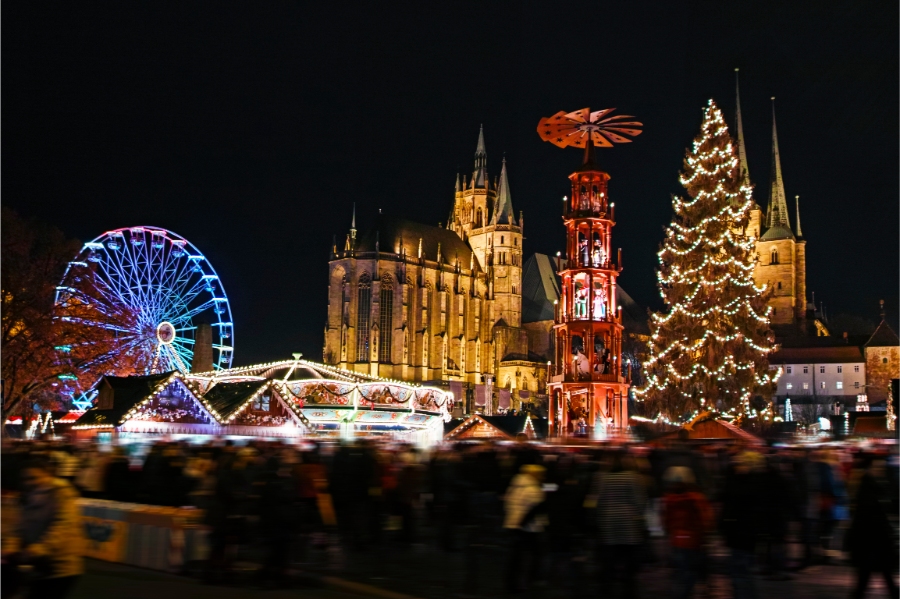The Ultimate Guide to German Christmas Markets 8 The Erfurt Christmas market showcases colorful stalls, holiday decorations, and people celebrating the festive season together.