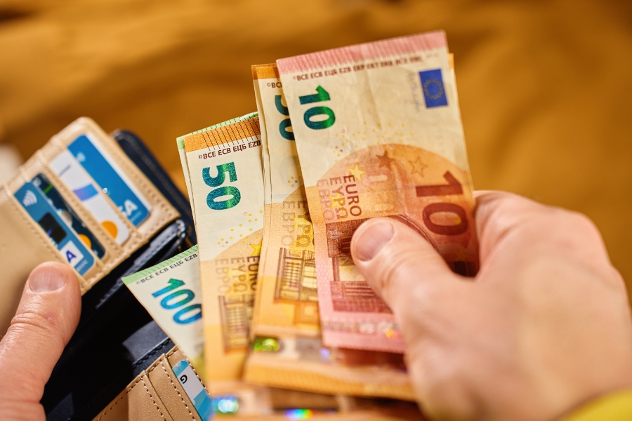 Pfand System Explained: Germany's Bottle Deposit Complete Guide 13 Close-up of a wallet containing euro banknotes and credit cards, representing personal finance and cash payment concepts.