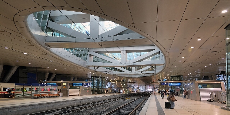 Frankfurt Airport 5 Frankfurt am Main train station bustling with travelers walking on the tracks, showcasing the station's vibrant atmosphere.