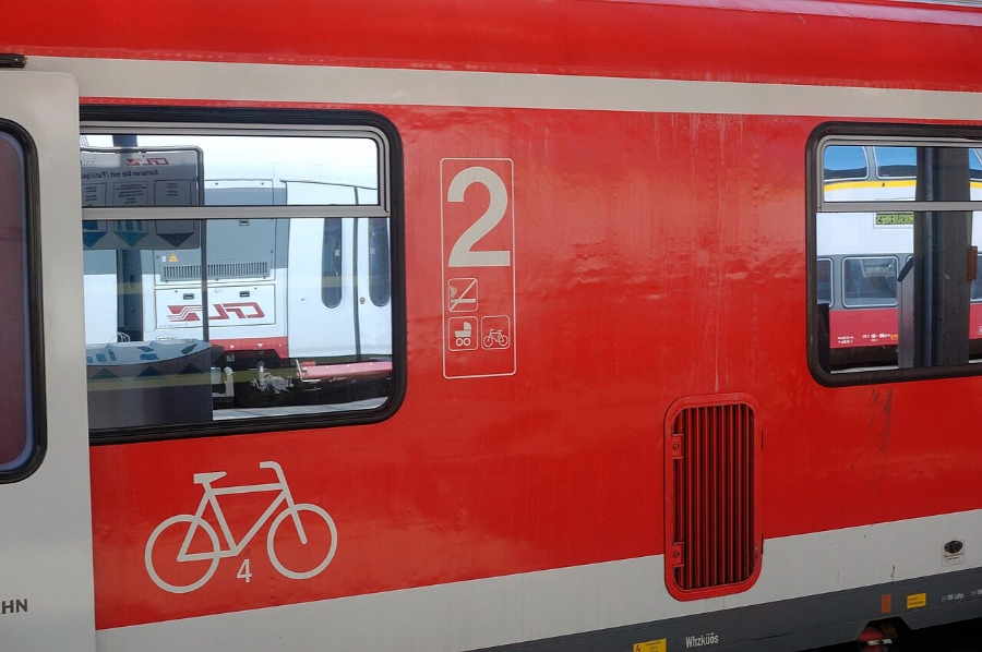 German Regional Day Tickets: Decision Trees for Maximum Savings 16 Red and white regional train in Germany, showcasing its sleek design at a railway station.