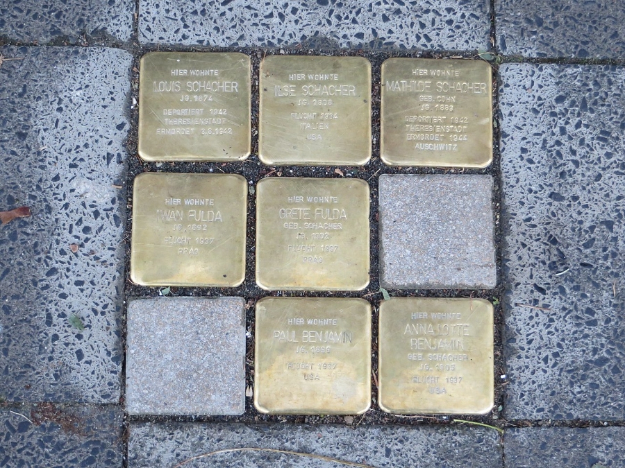 Six gold Stolpersteine plaques embedded in a sidewalk, commemorating victims of the Holocaust in Germany.