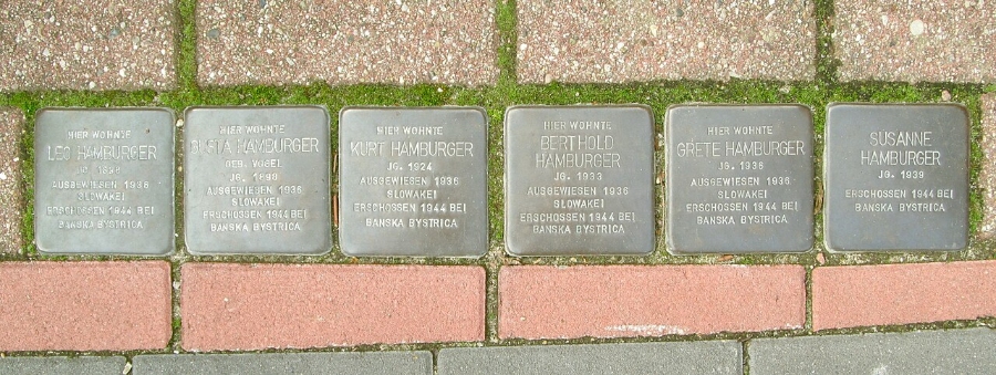 Cluster of six Stolpersteine plaques on the pavement, honoring Holocaust victims in Hamburg.
