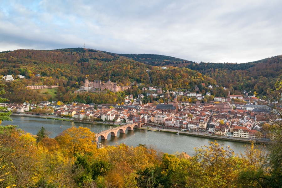 Best Time to Visit Germany: When to Go for Ideal Weather & Festivals 5 Panoramic view of Heidelberg, Germany, showcasing the city and river amidst vibrant autumn foliage.