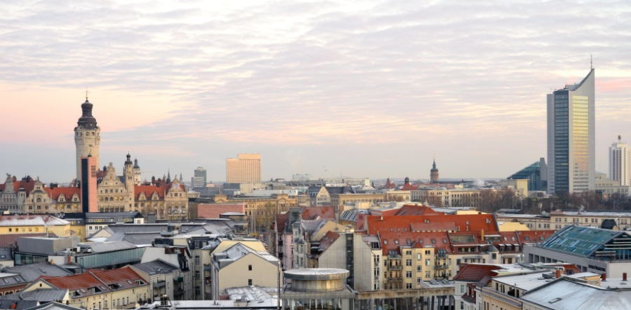 Morning skyline of Munich, Germany, showcasing modern and historic architecture against a clear blue sky.