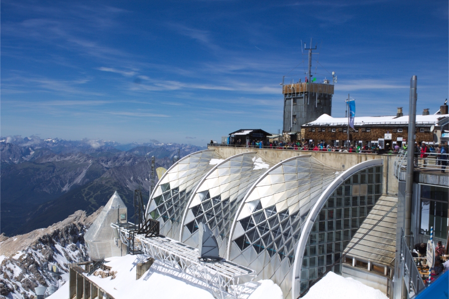 Zugspitze 13 The Münchner Haus, a prominent building, features a roof blanketed in snow, highlighting its winter charm.