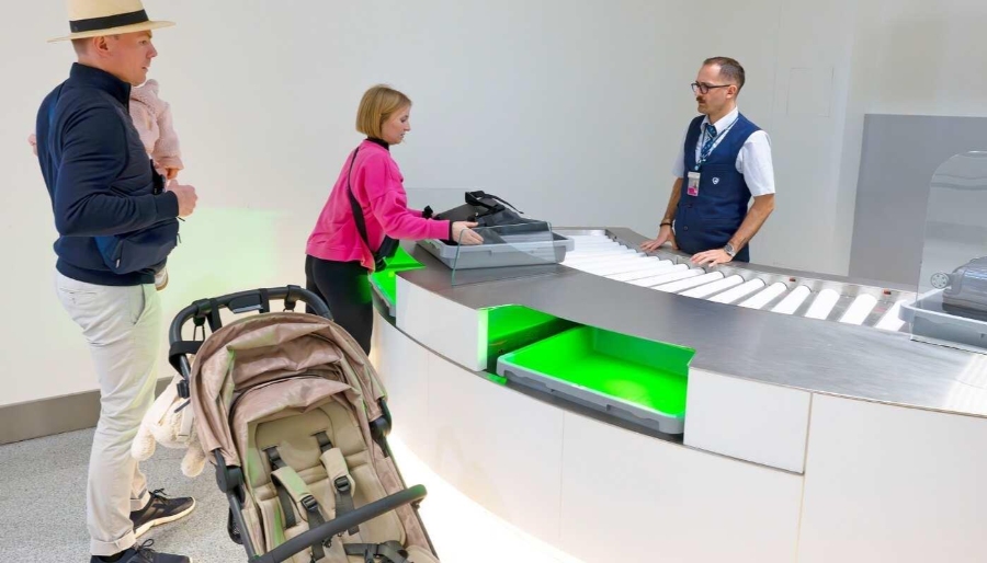 Munich Airport 20 Munich Airport, a man and woman are at a counter with a baby carriage, undergoing inspection procedures.