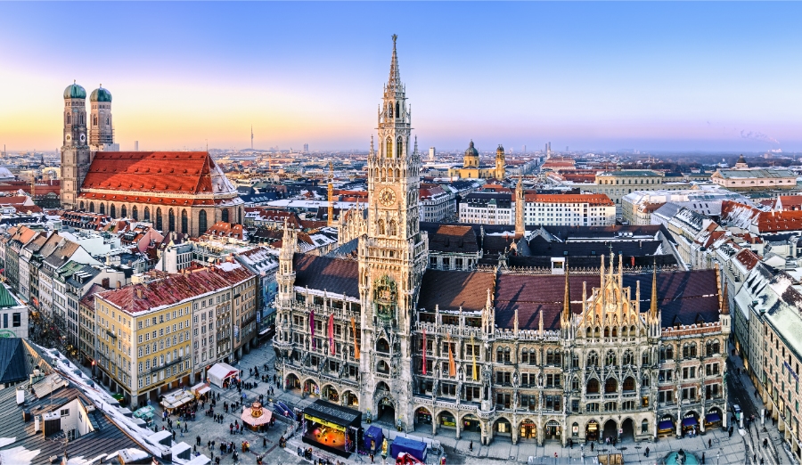 Planning a Trip to Germany: Step-by-Step Guide for First-Timers 9 Evening winter view of Munich, showcasing the city center with the cathedral and spire against a twilight sky.