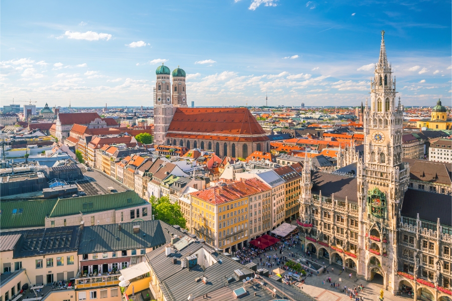 Planning a Trip to Germany: Step-by-Step Guide for First-Timers 4 Aerial view of Munich skyline showcasing historic buildings and modern architecture under a clear blue sky.
