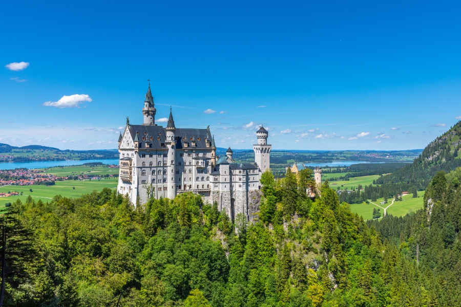 Germany Travel Guide: Ultimate Resource for Destinations, Culture & Tips 23 Scenic view of Neuschwanstein Castle in the Bavarian Alps, showcasing its 19th-century architecture against a summer landscape.