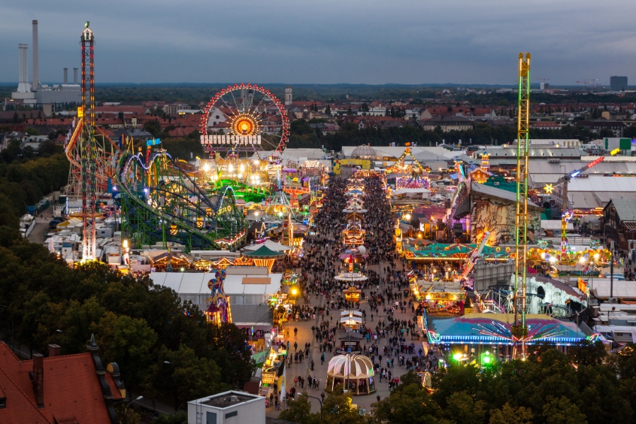 Best Time to Visit Germany: When to Go for Ideal Weather & Festivals 14 Aerial view of Oktoberfest in Munich at night, showcasing vibrant lights and bustling carnival activities.