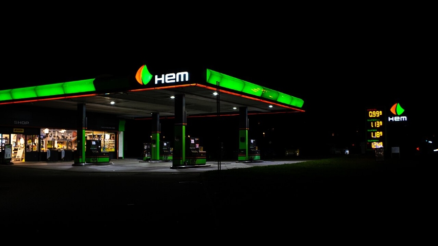Sunday & Quiet Hours in Germany: The Complete Survival Guide 8 Night view of a petrol station in Germany, featuring bright green and white lights highlighting the fuel pumps and building.