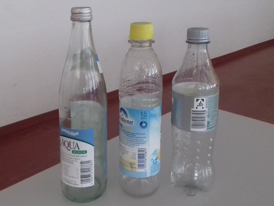 Pfand System Explained: Germany's Bottle Deposit Complete Guide 3 Close-up of various Pfand bottles, showcasing their labels and recycling symbols for bottle return.