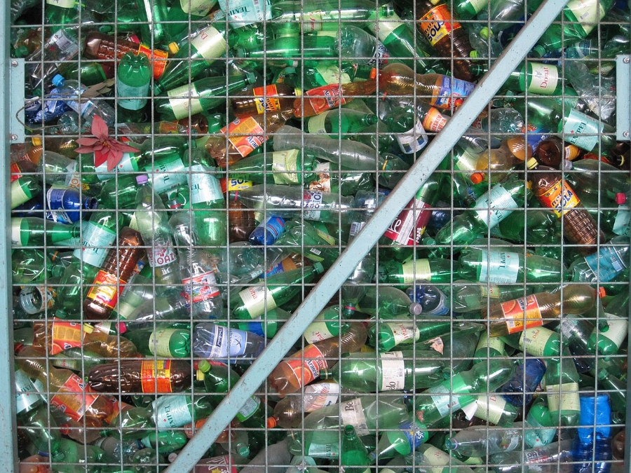 Pfand System Explained: Germany's Bottle Deposit Complete Guide 16 Collection of plastic bottles stored in a metal cage, emphasizing the importance of recycling and environmental sustainability.