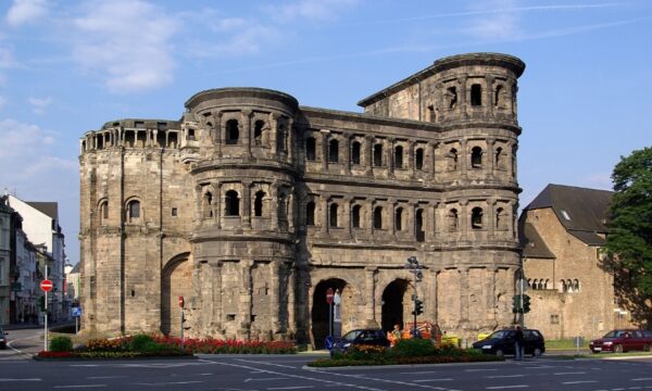 Porta Nigra, a historic Roman structure in Trier, featuring numerous windows and a prominent stone exterior.