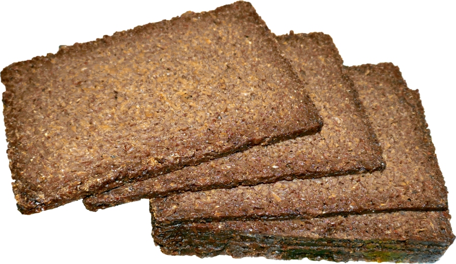 German Bread Culture: Bakeries, Loaves and Traditions 10 Several loaves of pumpernickel bread stacked together, displaying their rich brown color against a clean white backdrop.