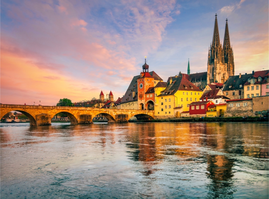 15 Best Places to Visit in Germany for an Unforgettable Trip 15 Sunset over Regensburg, Germany, showcasing the city's historic architecture and vibrant sky hues.