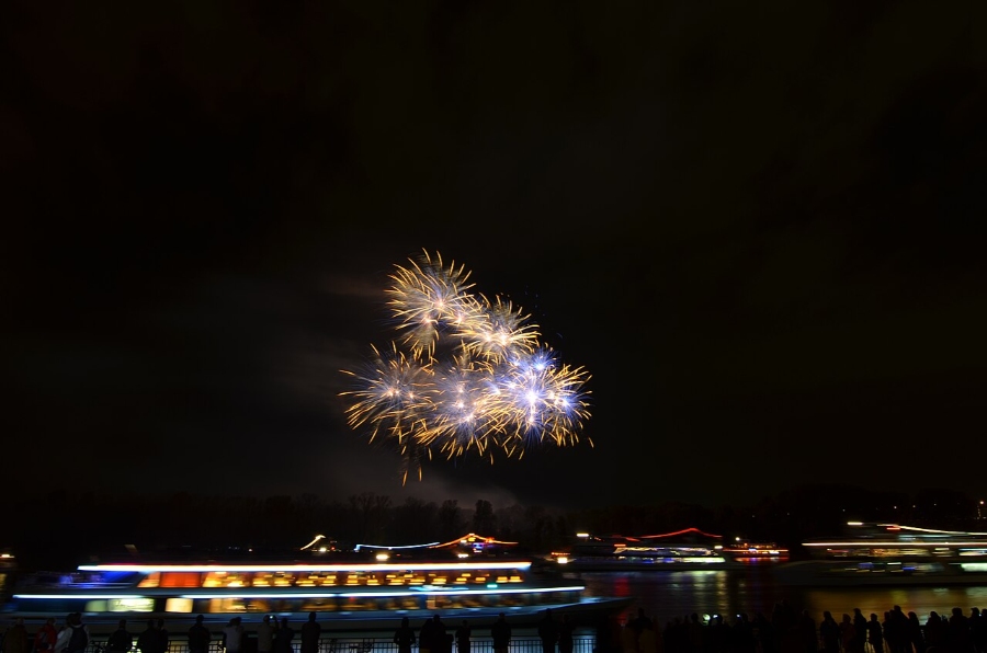 Middle Rhine Valley 20 Scenic view of a boat on the Rhine River, surrounded by vibrant fireworks lighting up the sky.