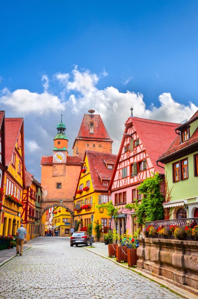 Exploring the German Castle Road: A Complete Guide 12 Scenic view of a cobblestone street in Rothenburg ob der Tauber, featuring a colorful building that highlights the town's beauty.