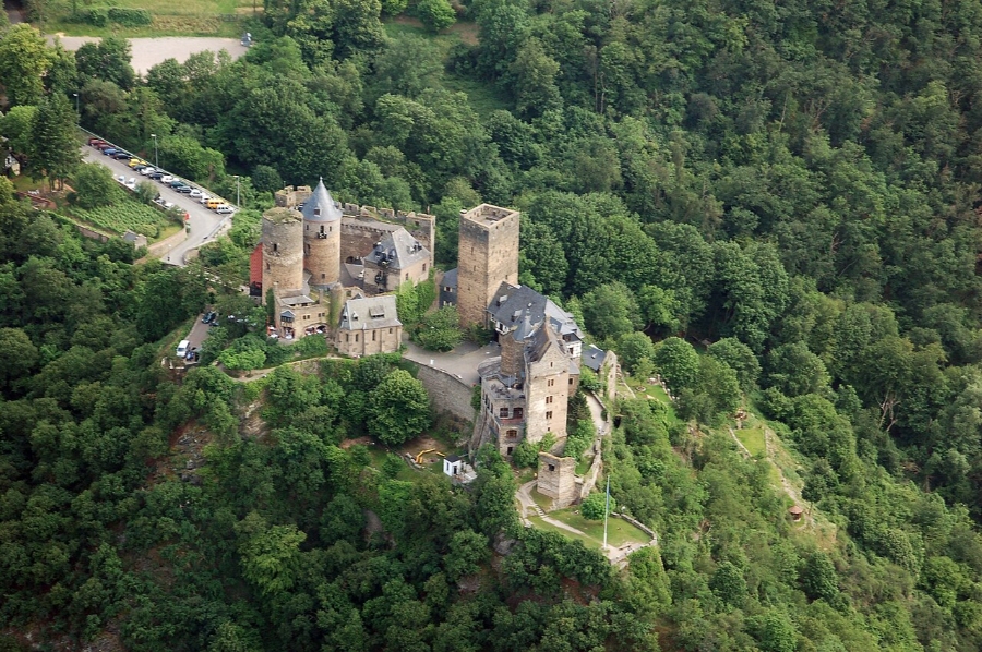 Middle Rhine Valley 12 Aerial view of Schönburg Castle perched on a hillside, surrounded by lush greenery and scenic landscape.