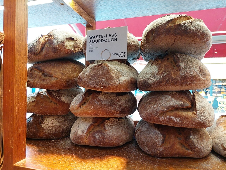 German Bread Culture: Bakeries, Loaves and Traditions 24 Selection of sourdough breads, featuring diverse shapes and golden-brown crusts, presented on a wooden display.