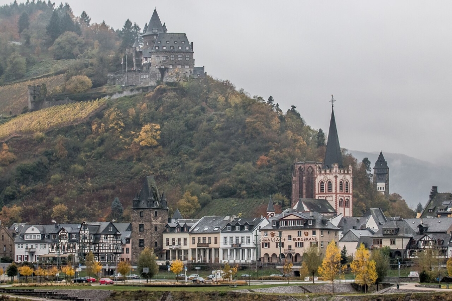 Middle Rhine Valley 2 Stahleck Castle overlooks the town of Bacharach along the Rhine Gorge, surrounded by lush hills and the river below.