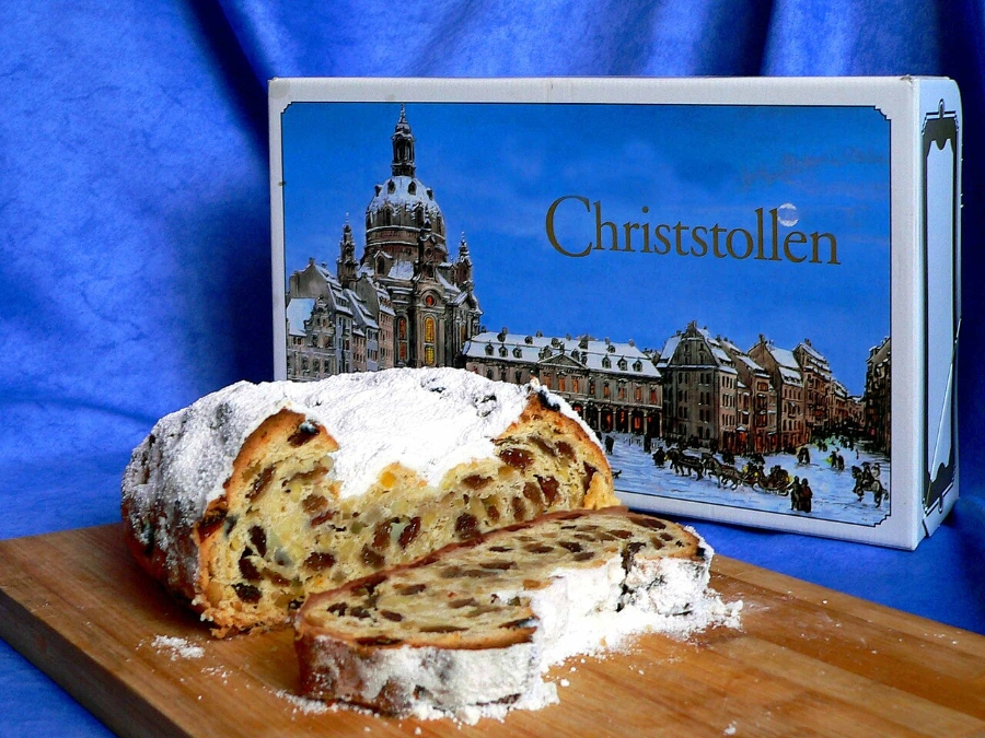 German Christmas Traditions: A Complete Guide 22 Beautifully presented Stollen Christmas bread next to an elegant box, highlighting its seasonal charm and deliciousness.