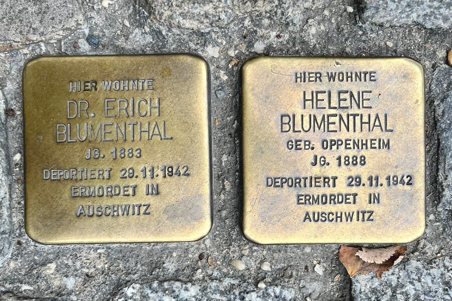 Two bronze Stolpersteine plaques embedded in the ground, commemorating the names of two individuals in Germany.