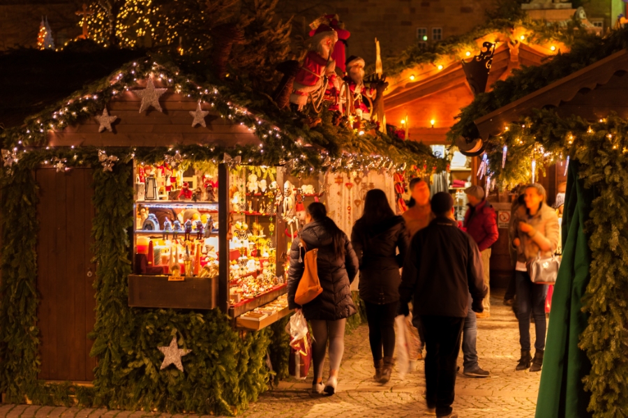The Ultimate Guide to German Christmas Markets 6 Stuttgart's city center adorned with holiday lights, showcasing a vibrant Christmas market filled with stalls and cheerful crowds.