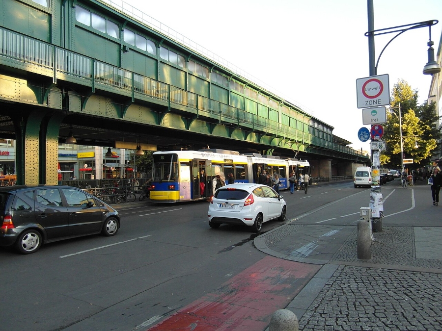 Umweltzone Guide: Germany's Low-Emission Zones Explained for Tourists 15 Street scene in Berlin, Germany, featuring cars and a bus in an environmental zone.