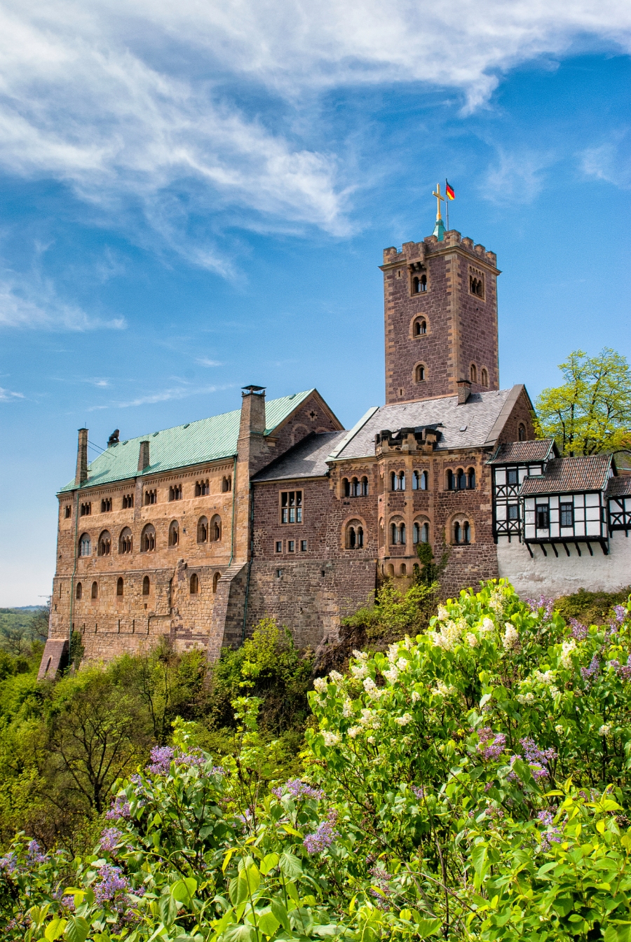 Planning a Trip to Germany: Step-by-Step Guide for First-Timers 29 Close-up view of Wartburg Castle, showcasing its medieval architecture and surrounding greenery.