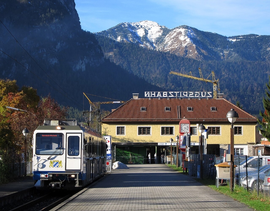 Zugspitze 16 Zugspitzbahn train traveling along the tracks, surrounded by scenic mountainous terrain.
