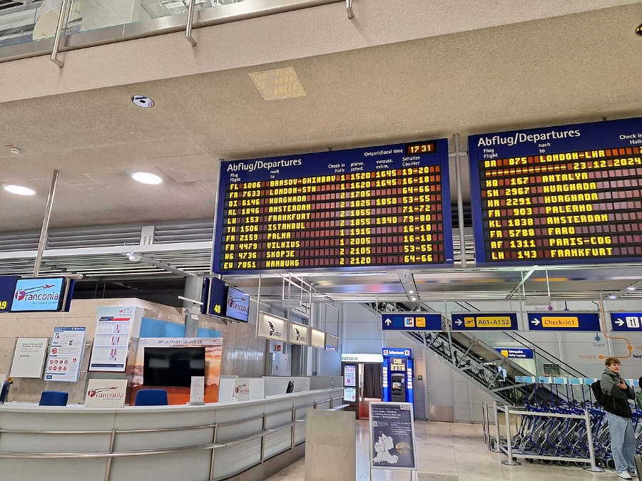 Nuremberg Airport 4 Nuremberg Airport terminal featuring a prominent departure sign and bustling passenger activity.