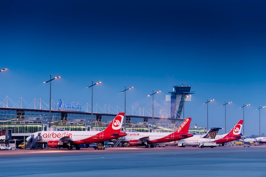 Nuremberg Airport 6 Multiple airplanes lined up at Nuremberg Airport, Germany, highlighting the busy atmosphere of the aviation hub.
