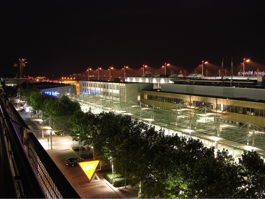 Nuremberg Airport 7 Night view of Nuremberg Airport terminal, illuminated with lights against a dark sky, showcasing modern architecture.