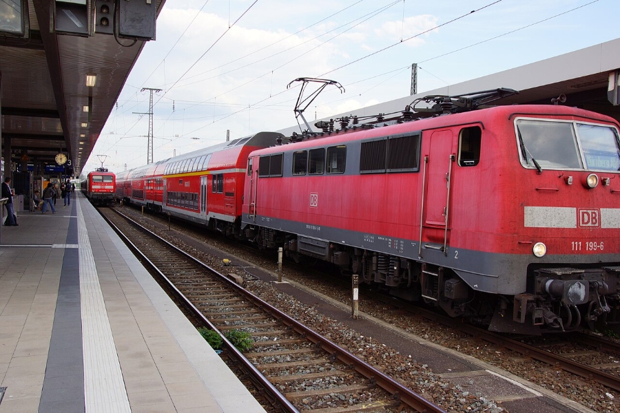 Nuremberg Airport 11 Red train waits on the tracks at Nürnberg Hauptbahnhof, showcasing the bustling atmosphere of the train station.
